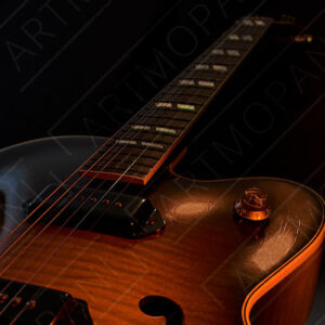 hollow body electric guitar in dramatic light