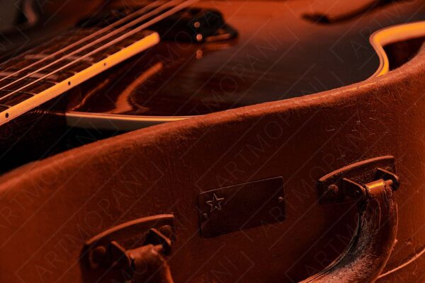 vintage guitar and guitar case in warm moody light