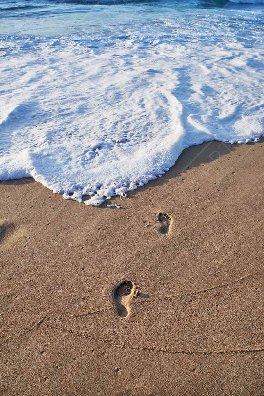 Footprints on a Sunny Beach