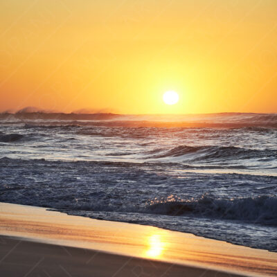 Sunrise Over Breaking Waves