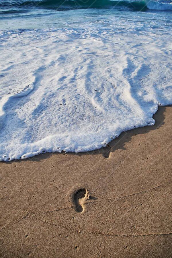 footprints by the sea